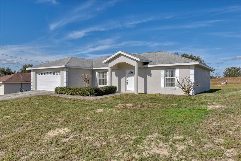 59 Juniper Trail Loop Ocala, FL 34480 - Photo 1 of 1 a front view of a house with a garden