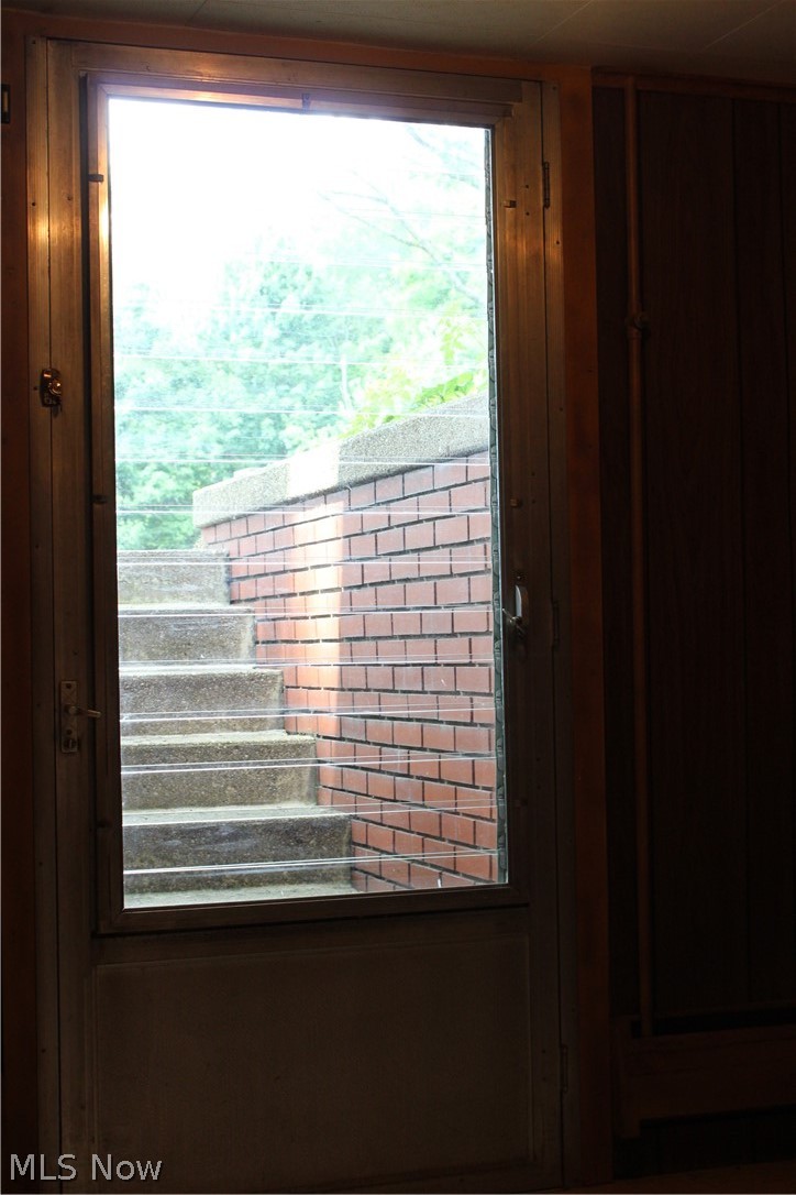 8818 Carnes Road Chagrin Falls, OH 44023 - Photo 17 of 30 Walk out lower level stairs designed with heat tape for winter use. The heat tape is controlled by a switch to the right of the door.