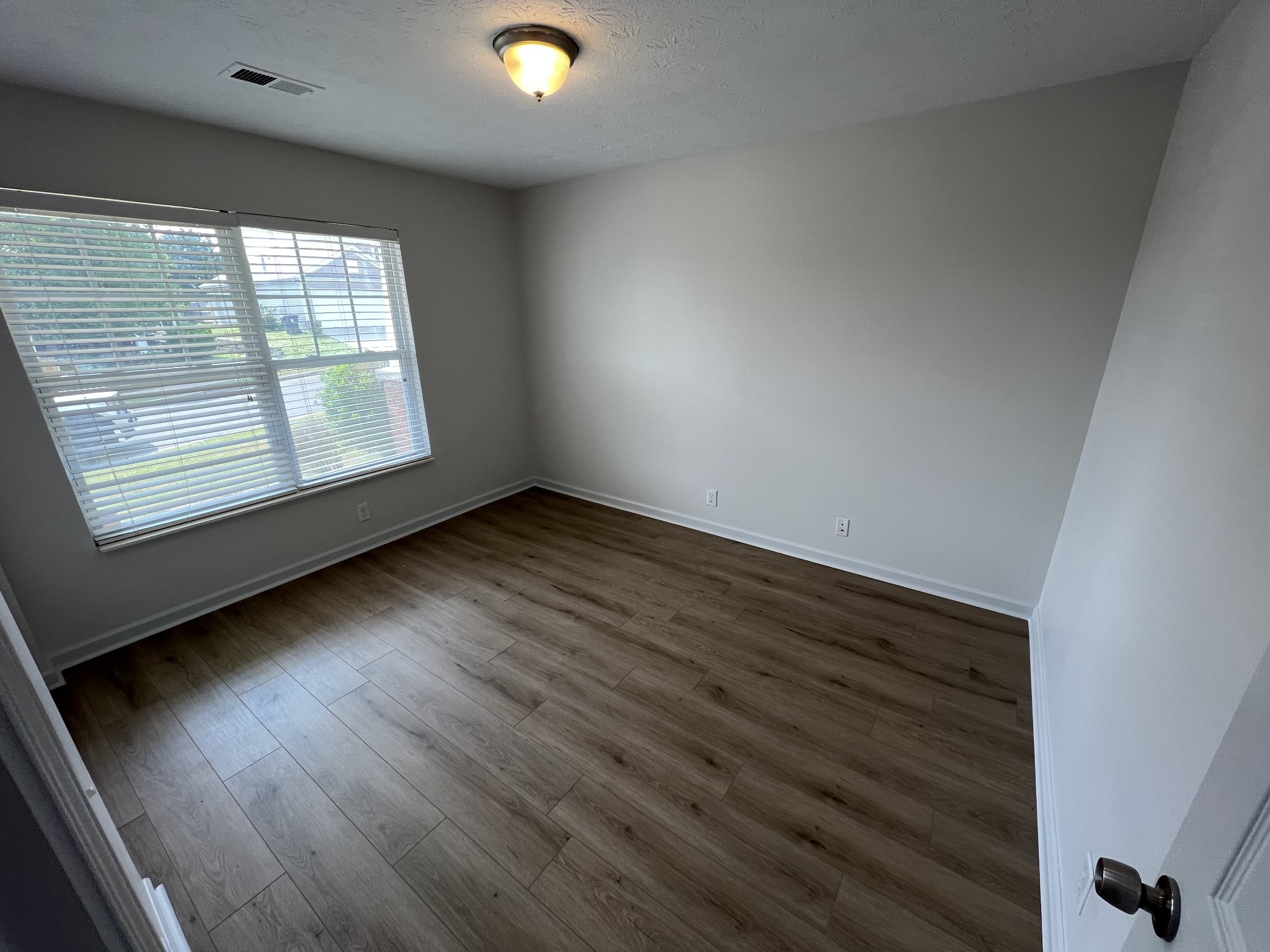 3965 Stephens Ridge Way Antioch, TN 37013 - Photo 12 of 17 an empty room with wooden floor and windows