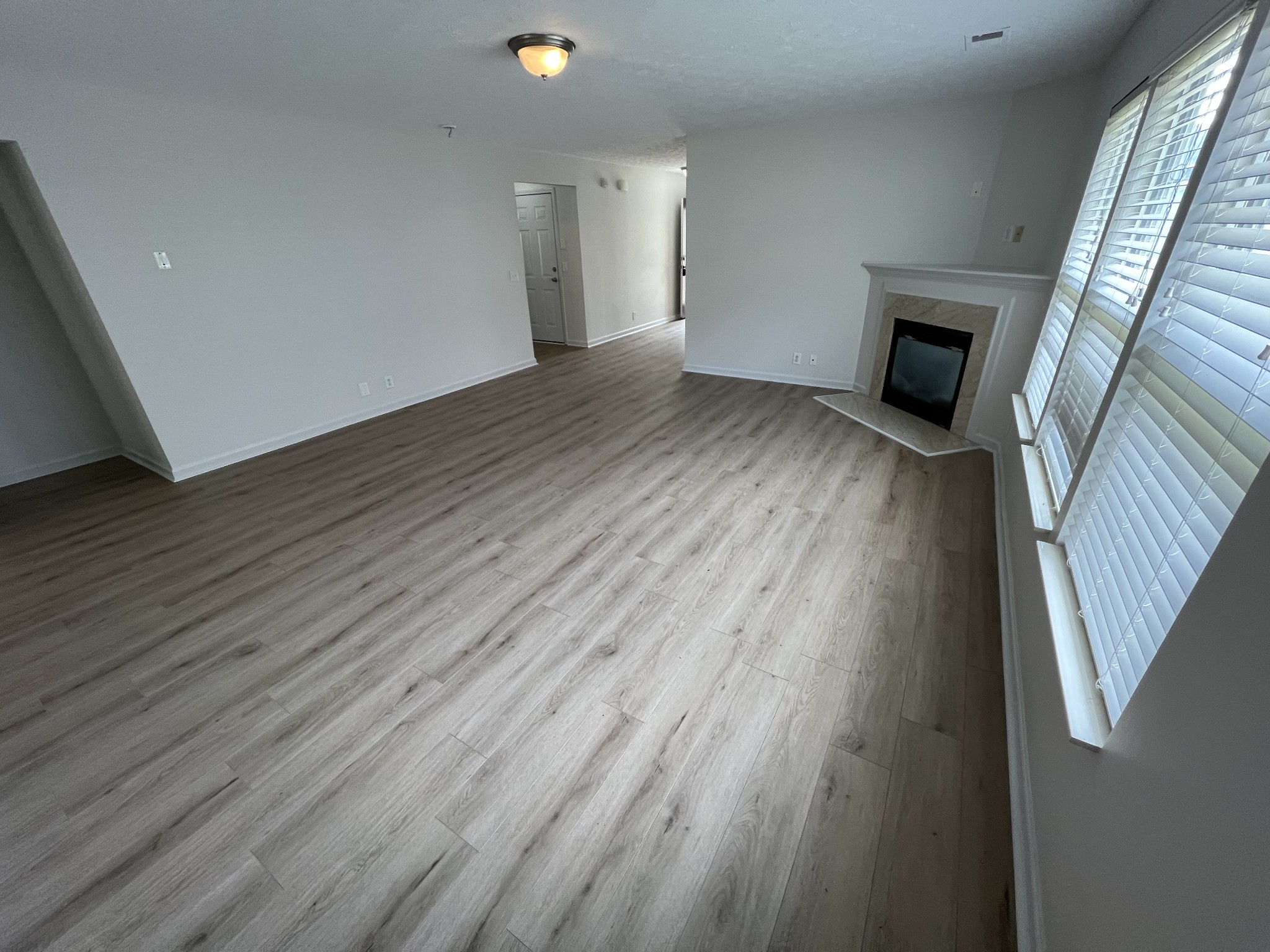 3965 Stephens Ridge Way Antioch, TN 37013 - Photo 5 of 17 an empty room with wooden floor and fireplace