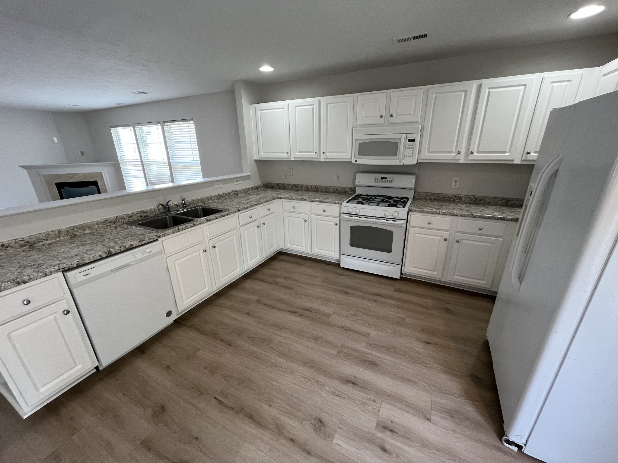 3965 Stephens Ridge Way Antioch, TN 37013 - Photo 7 of 17 a kitchen with granite countertop white cabinets and white appliances
