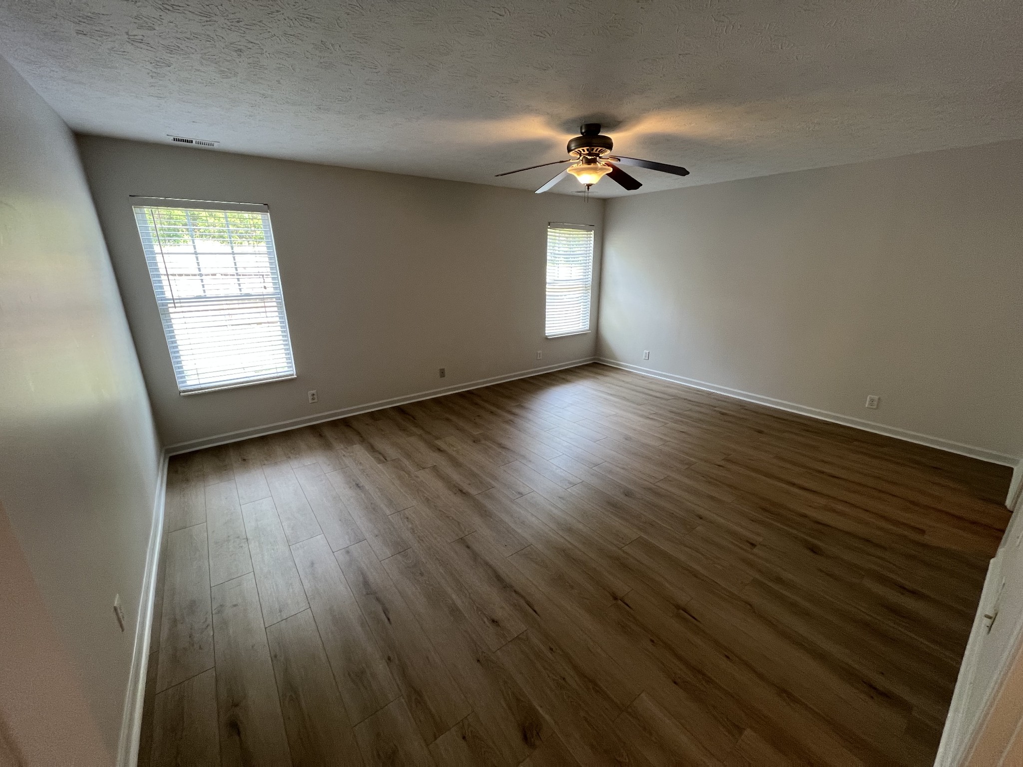 3965 Stephens Ridge Way Antioch, TN 37013 - Photo 8 of 17 a view of an empty room with wooden floor and a window