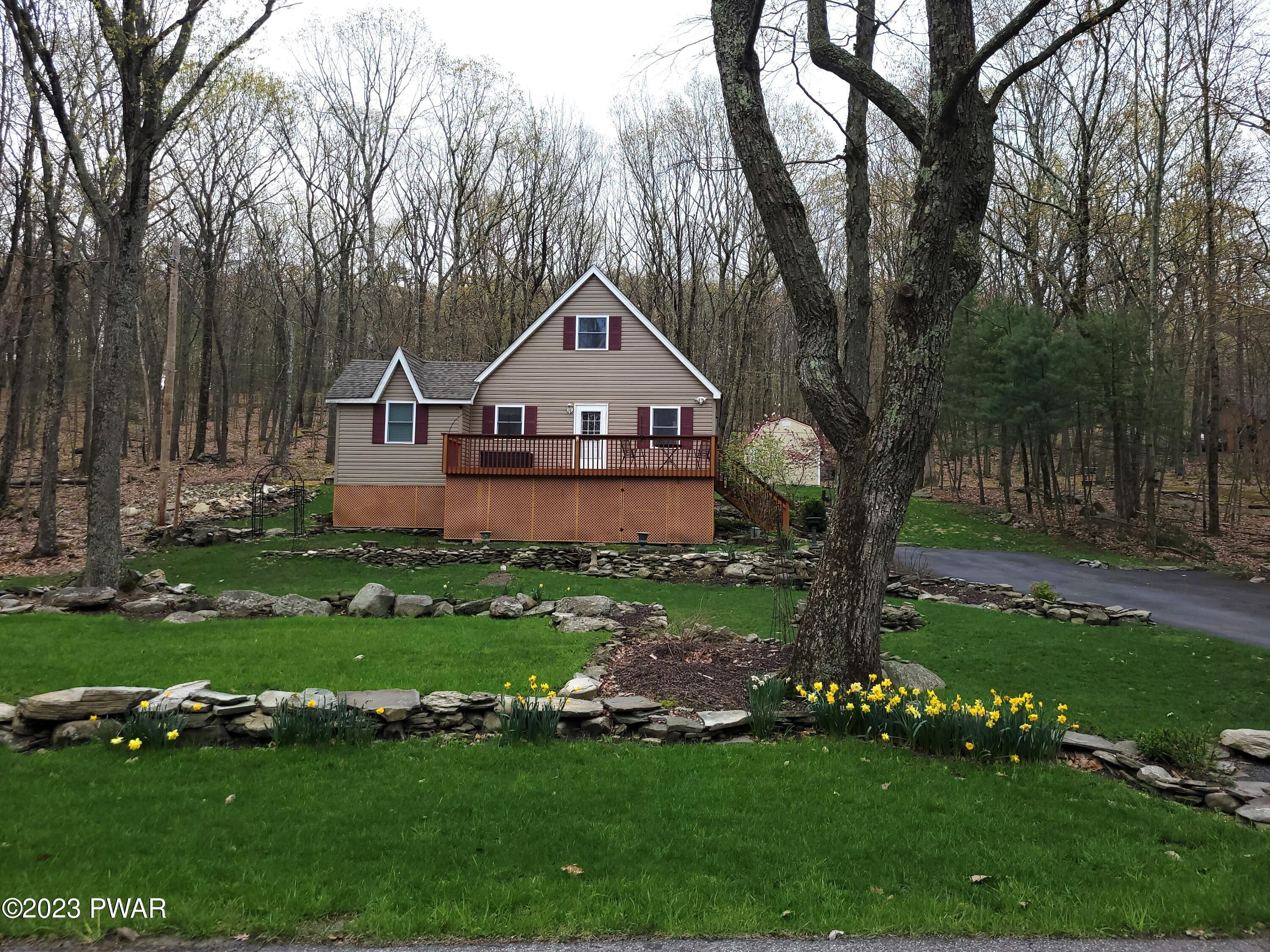 122 Hemlock Road Milford, PA 18337 - Photo 2 of 19 a front view of a house with a yard