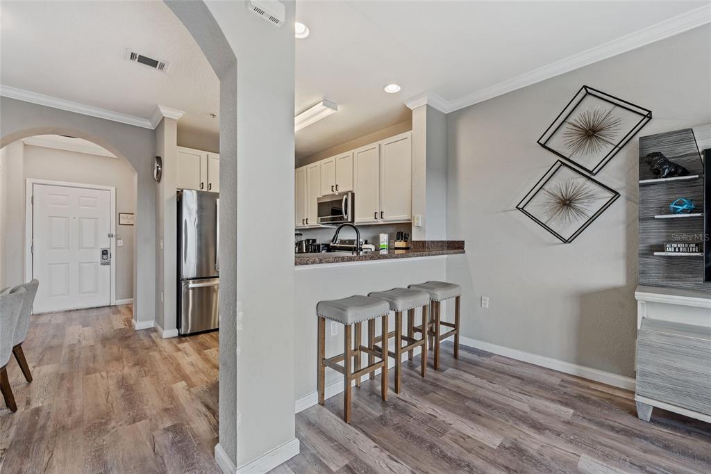14200 Avalon Road, Unit 409 Winter Garden, FL 34787 - Photo 14 of 33 a kitchen with stainless steel appliances granite countertop a refrigerator and a stove top oven