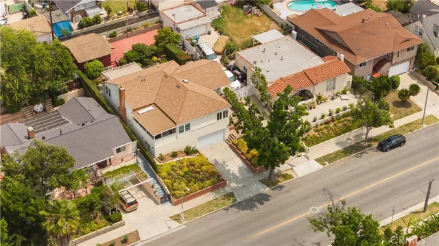 an aerial view of a residential houses with street