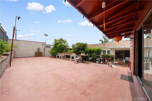 a view of a house with a yard and sitting area