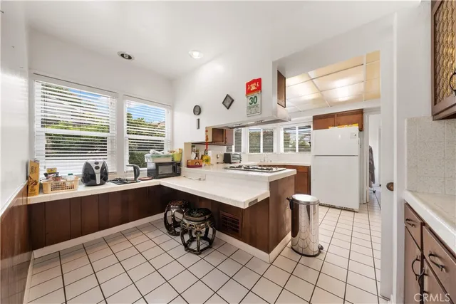 a kitchen with a sink refrigerator and cabinets