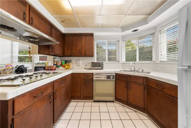 a kitchen with a sink window and cabinets