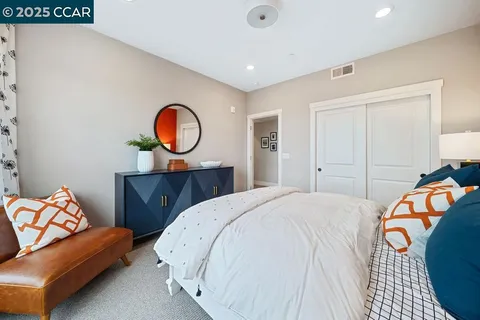 a bedroom with a bed and a couch