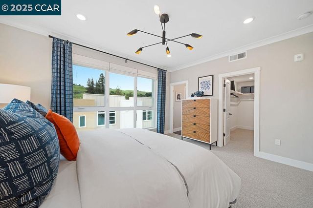 a bedroom with a large bed and a large window