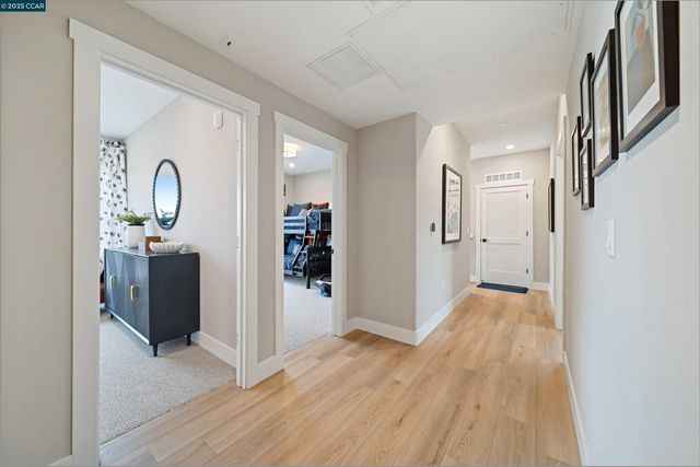 a view of a room with wooden floor and furniture