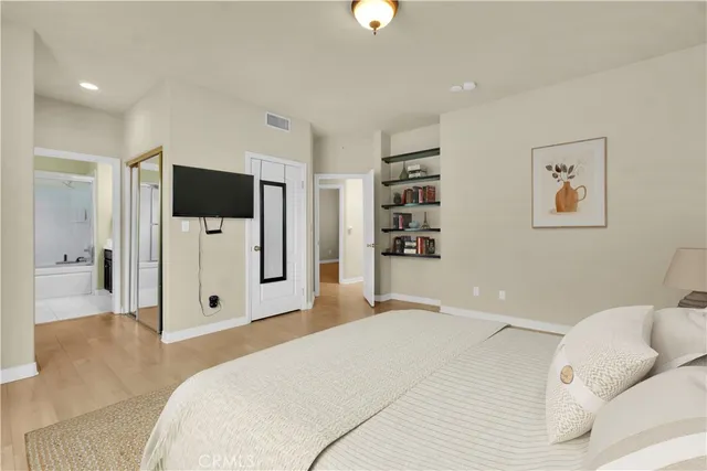 a bedroom with a large bed and a large window