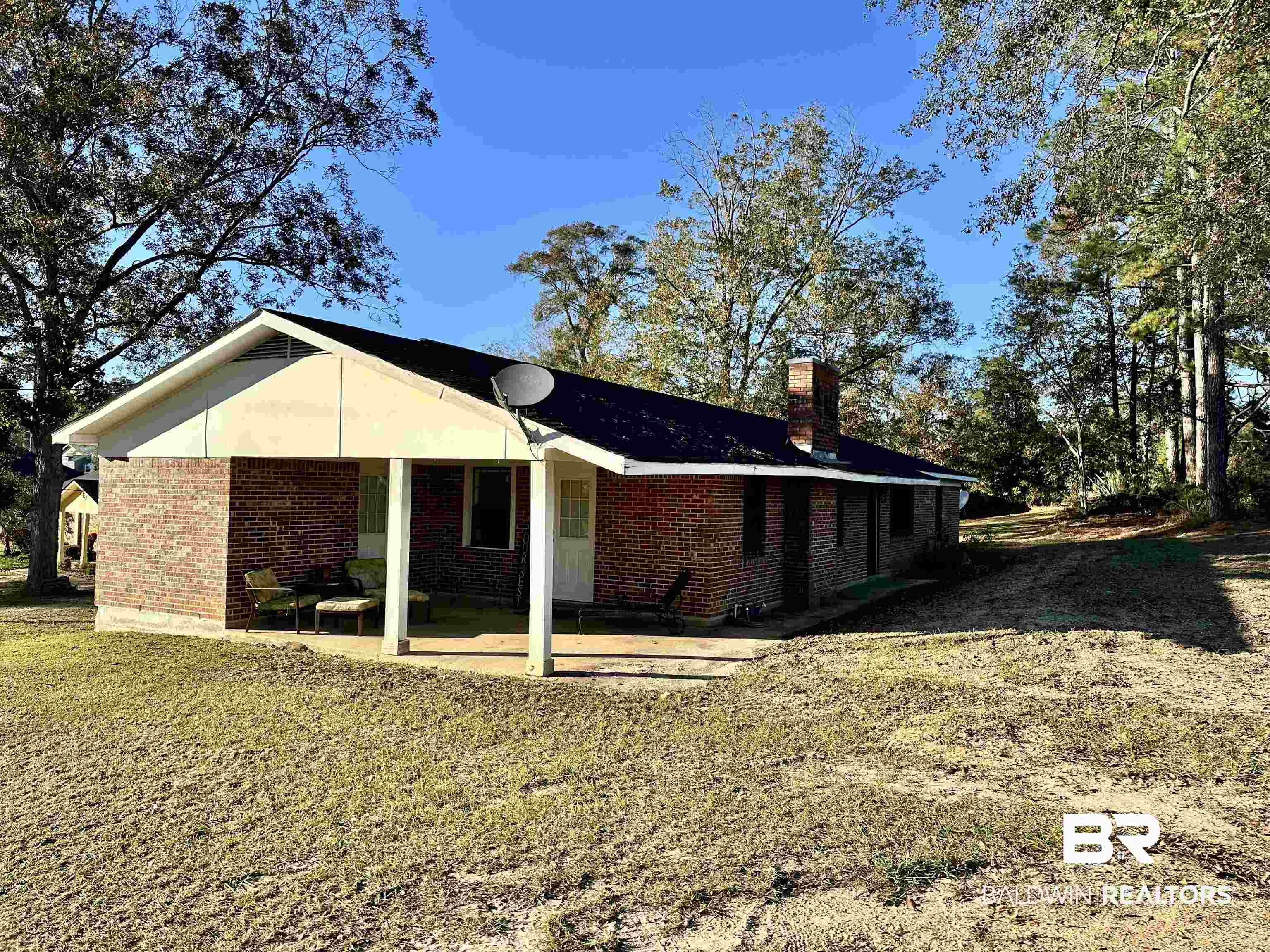 3451 Kirkland Road Brewton, AL 36426 - Photo 17 of 17 Rear view of house featuring a yard