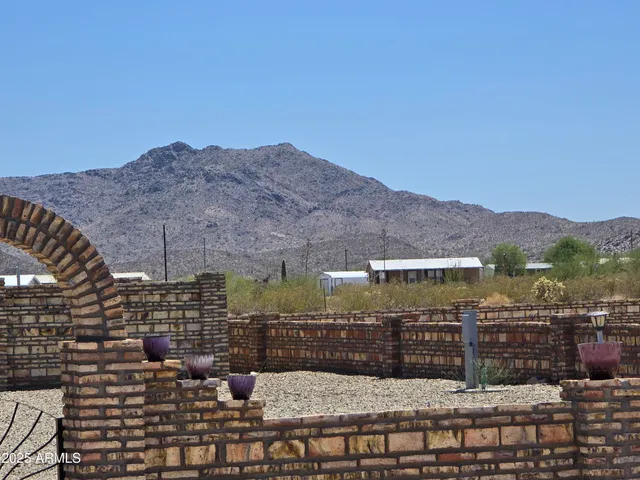 a view of a balcony with a yard