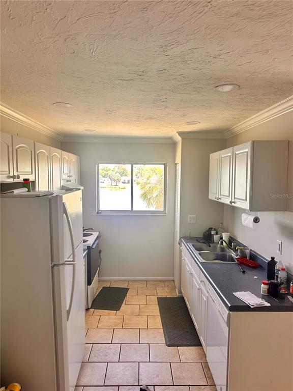 2948 Clark Road, Unit 224 Sarasota, FL 34231 - Photo 5 of 8 a kitchen with a sink a refrigerator and window