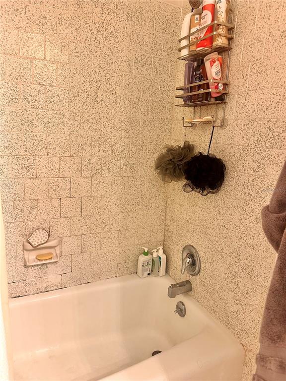 2948 Clark Road, Unit 224 Sarasota, FL 34231 - Photo 6 of 8 a bathroom with a sink and a granite countertop