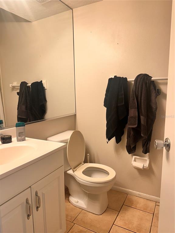 2948 Clark Road, Unit 224 Sarasota, FL 34231 - Photo 7 of 8 a bathroom with a toilet sink and mirror
