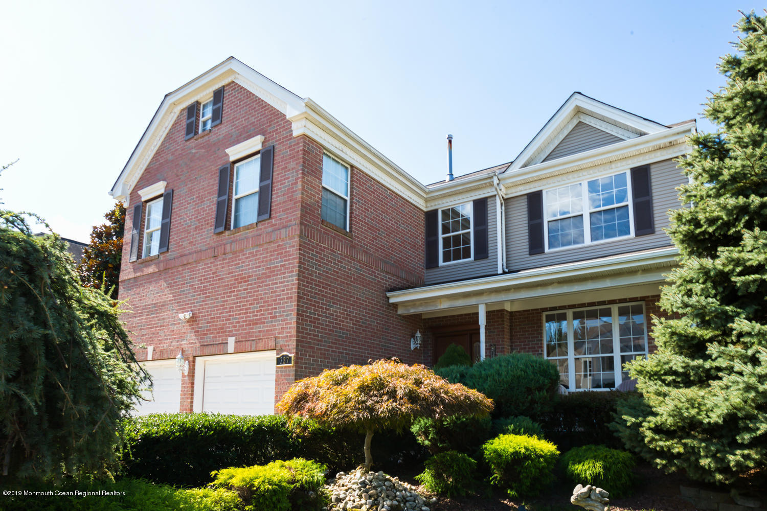 a front view of a house with a yard and outdoor seating
