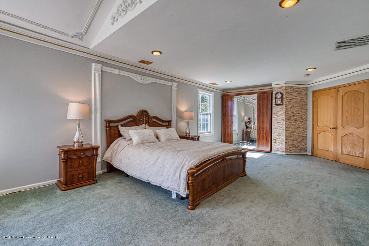 327 Wedgewood Road Morganville, NJ 07751 - Photo 14 of 33 a bedroom with a bed lamp and a large window