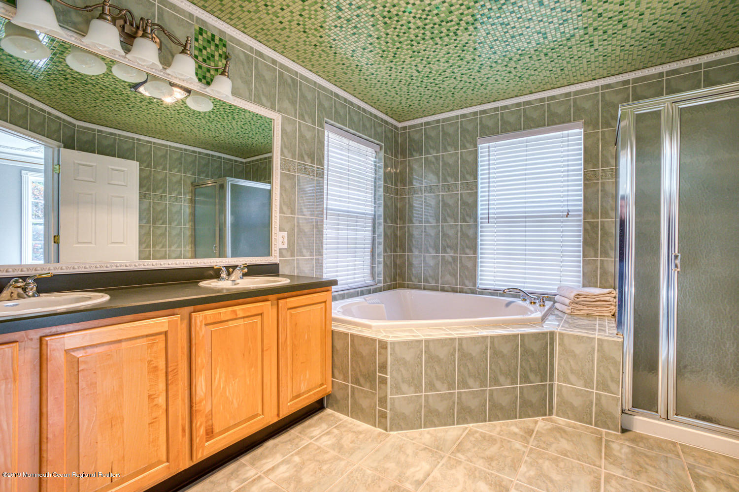 327 Wedgewood Road Morganville, NJ 07751 - Photo 15 of 33 a bathroom with a tub sink and mirror
