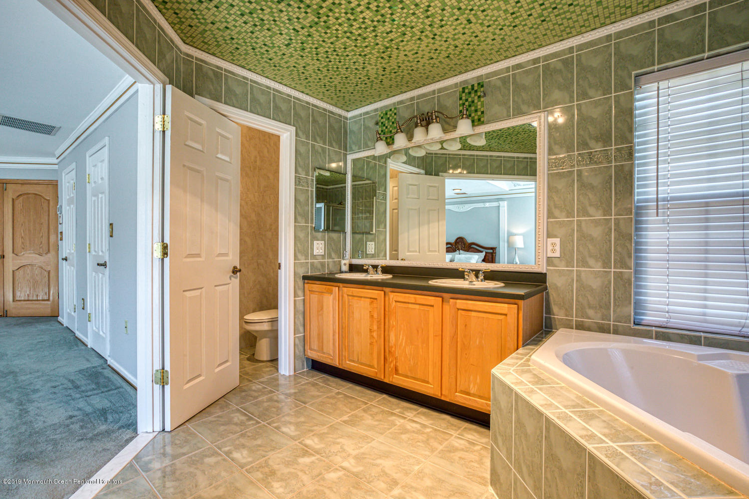 327 Wedgewood Road Morganville, NJ 07751 - Photo 16 of 33 a bathroom with a granite countertop sink and a bathtub