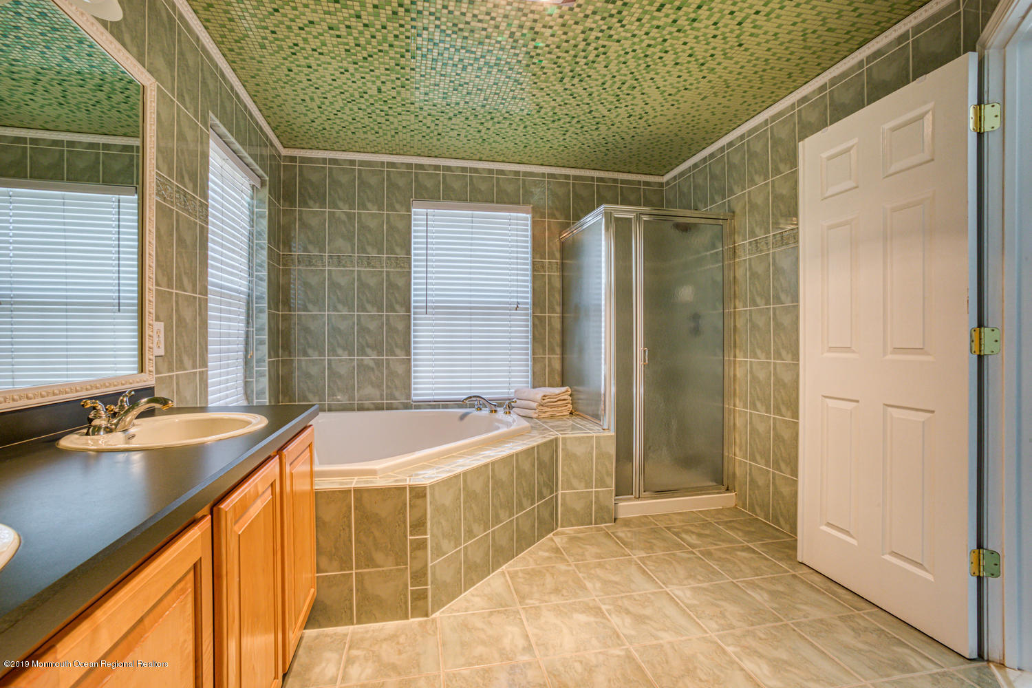 327 Wedgewood Road Morganville, NJ 07751 - Photo 17 of 33 a bathroom with a tub sink and mirror