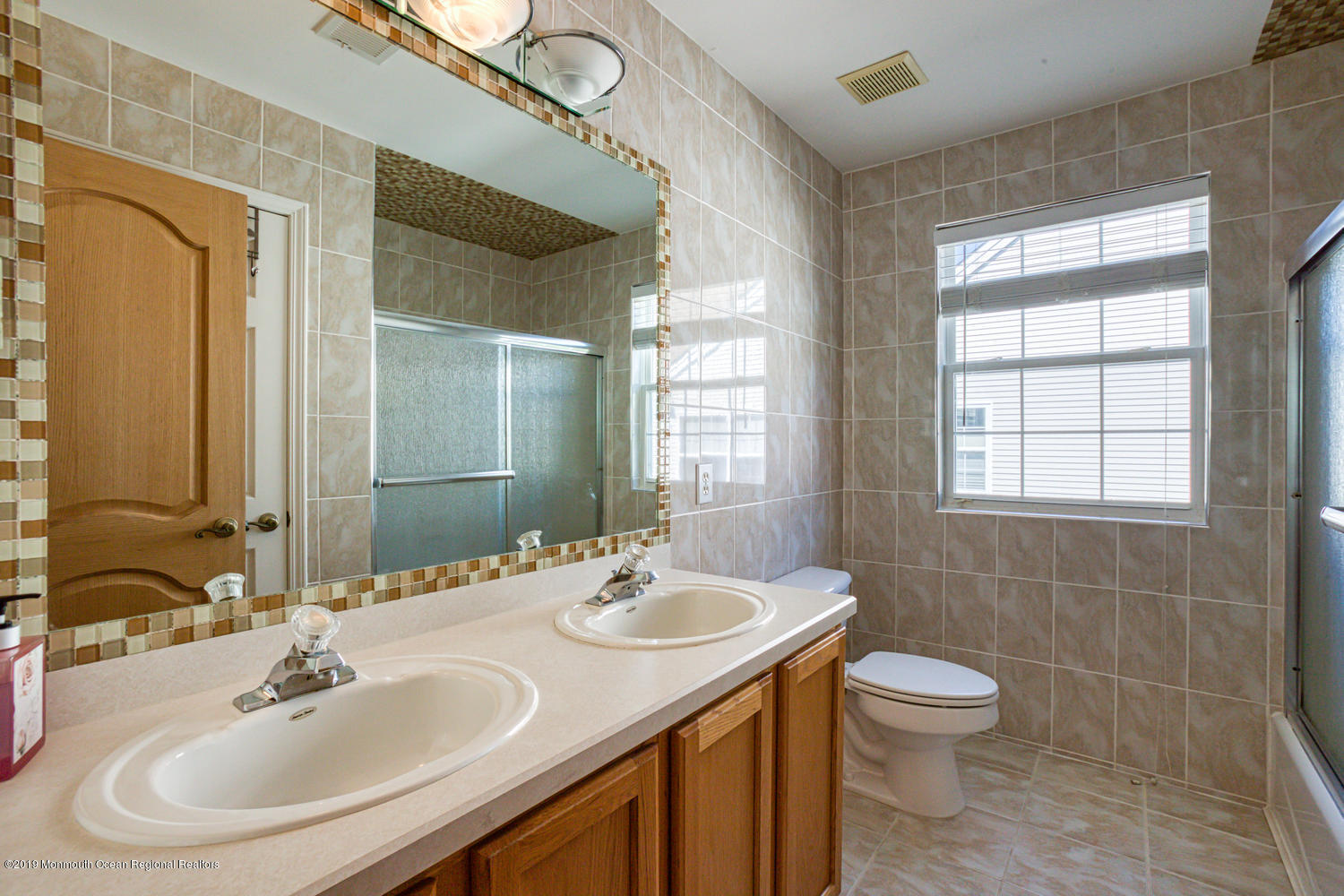 327 Wedgewood Road Morganville, NJ 07751 - Photo 20 of 33 a bathroom with a sink and a mirror