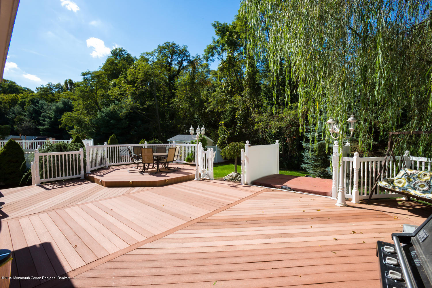 327 Wedgewood Road Morganville, NJ 07751 - Photo 24 of 33 a view of a wooden deck and a patio with swimming pool