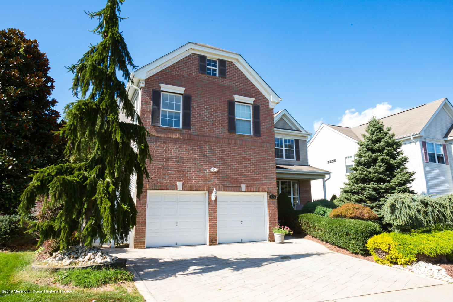 327 Wedgewood Road Morganville, NJ 07751 - Photo 31 of 33 a front view of a house with a yard