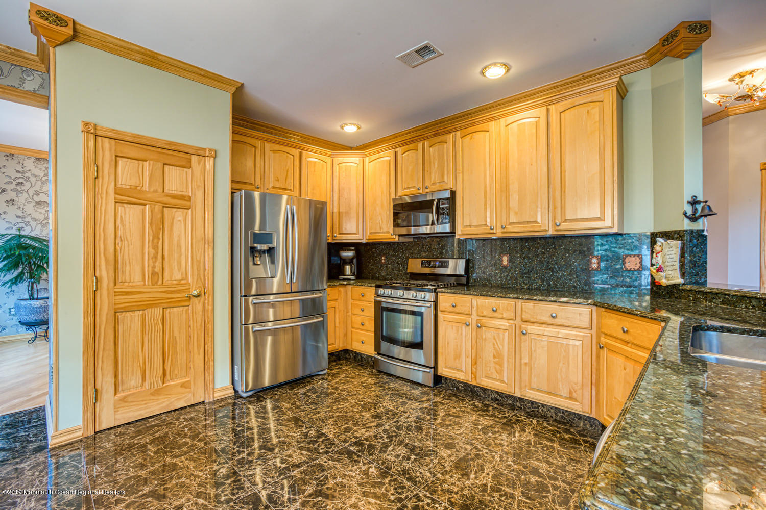327 Wedgewood Road Morganville, NJ 07751 - Photo 5 of 33 a kitchen with stainless steel appliances granite countertop a refrigerator a stove a sink and a granite counter tops with white cabinets