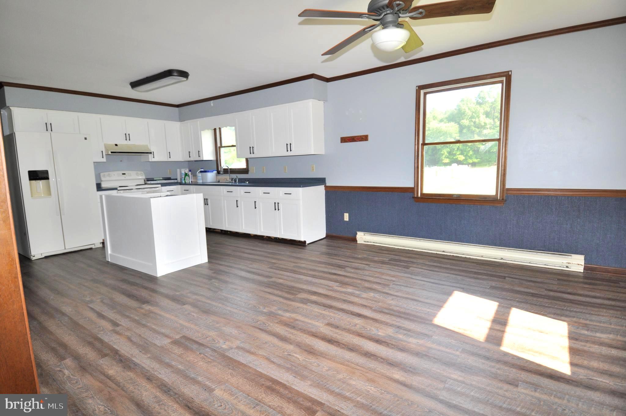 31881 Mitchell Road Princess Anne, MD 21853 - Photo 13 of 60 a kitchen with a refrigerator wooden floor and window