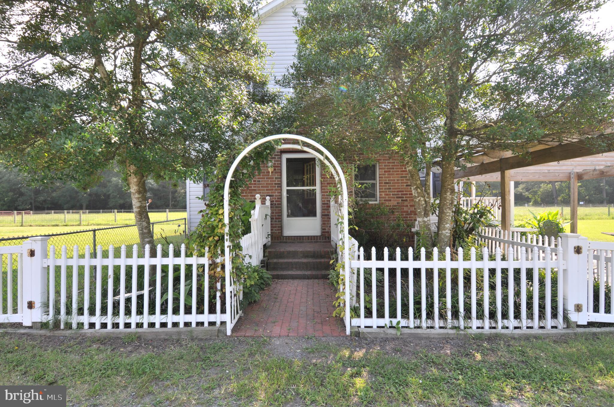 31881 Mitchell Road Princess Anne, MD 21853 - Photo 5 of 60 a view of a wooden house with a small yard