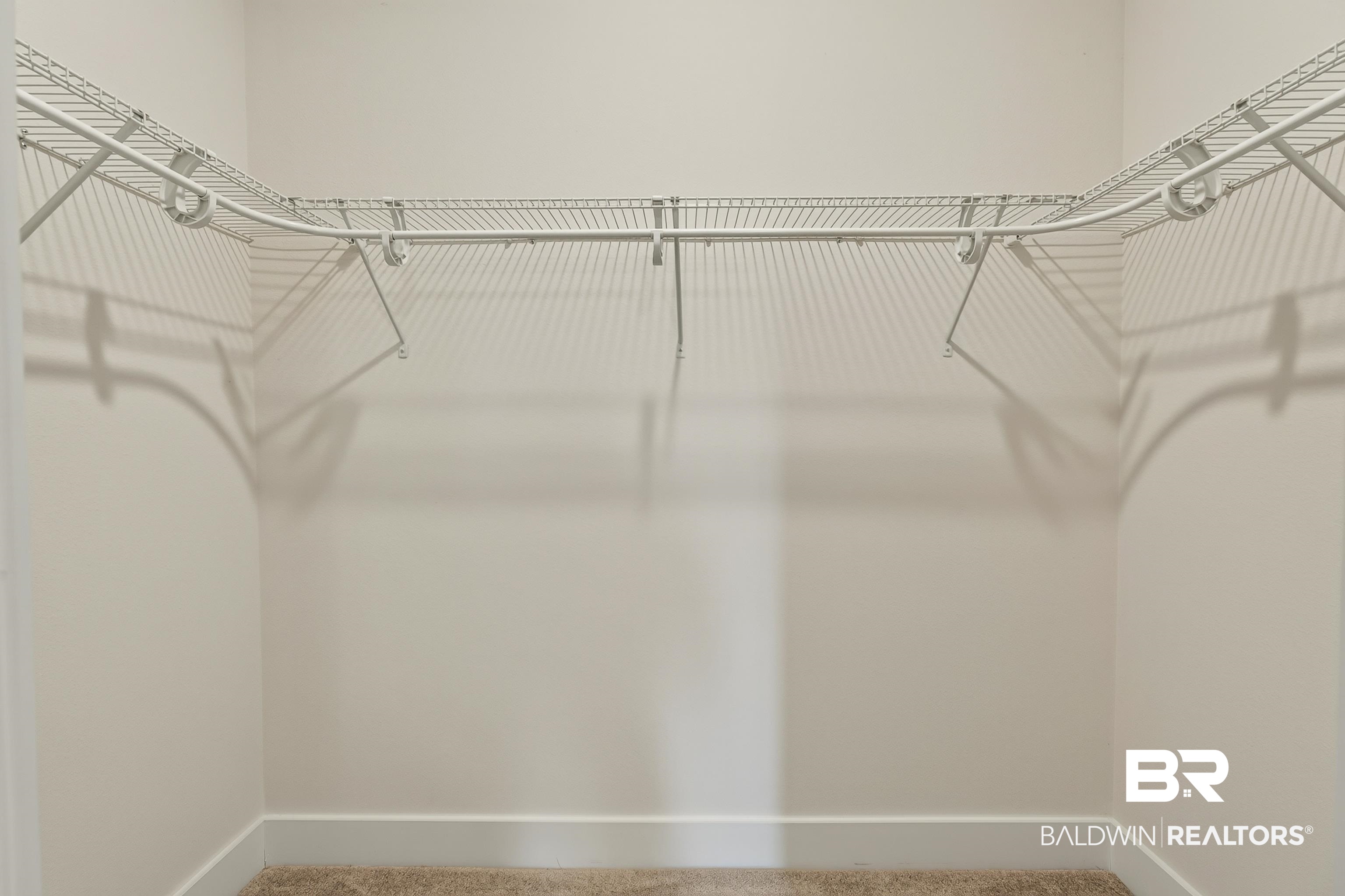 1724 Partridge Street Foley, AL 36535 - Photo 45 of 62 Walk-in closet with white wire shelving and hanging rods