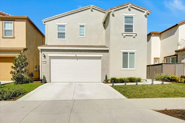 a front view of a house with a yard