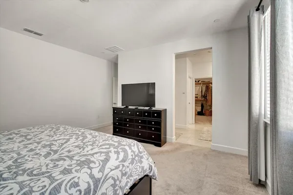 a bedroom with a bed and a television