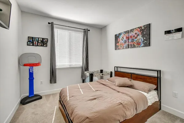 a bedroom with bed and a window