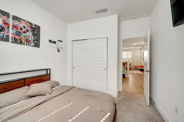 a bedroom with a bed and a view of bathroom