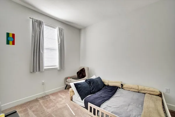 a bedroom with a bed and window