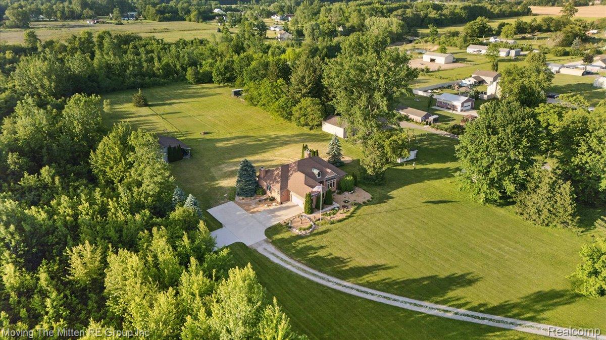 39750 Willow Road New Boston, MI 48164 - Photo 51 of 68 Expansive property featuring a brick residence, attached garage, and a long gravel driveway