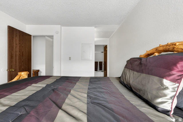 407 South Vasels Road, Unit 24 Brian Head, UT 84719 - Photo 19 of 63 Bedroom featuring a textured ceiling, electric panel, and a closet