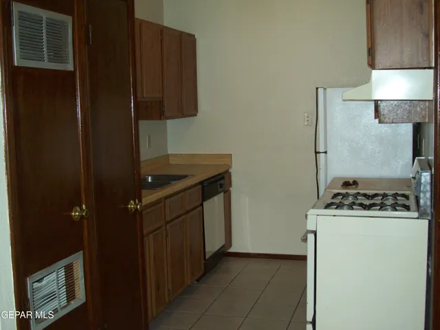 a kitchen with a stove and a refrigerator