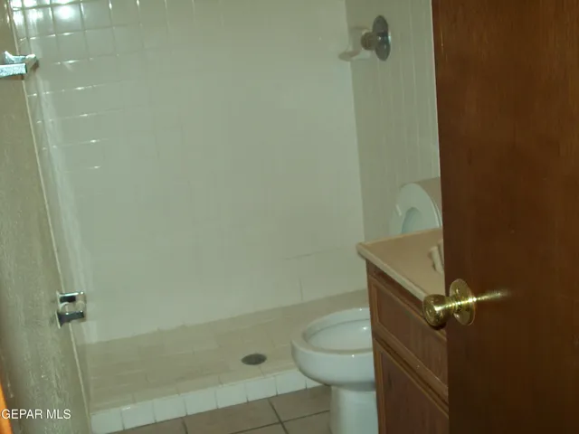 a bathroom with a granite countertop shower