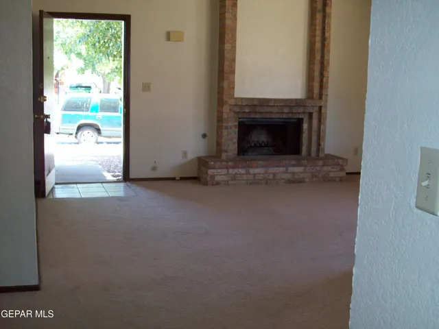 a view of empty room with a fireplace