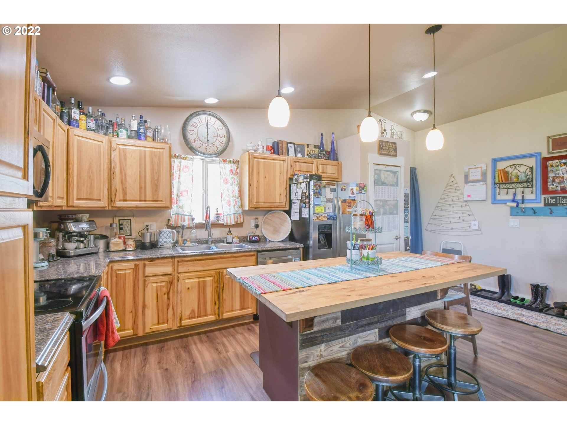 831 South Main Street Pendleton, OR 97801 - Photo 12 of 26 a kitchen with kitchen island granite countertop a sink cabinets and stove