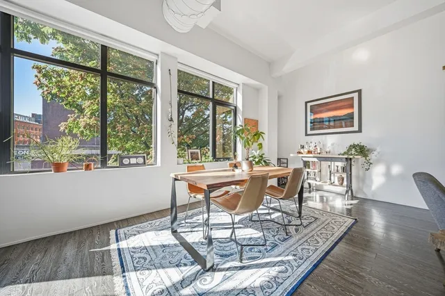 a dining room with furniture wooden floor and a rug