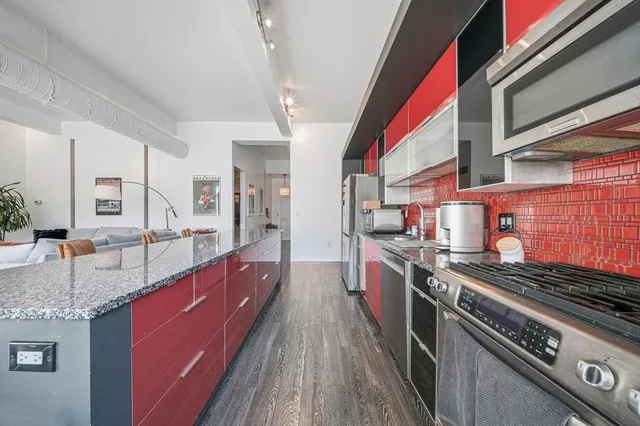 a kitchen with stainless steel appliances granite countertop a stove and a sink