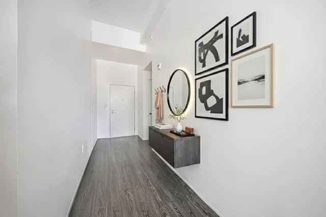 a view of a hallway with wooden floor