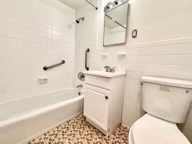 a bathroom with a toilet a sink and bathtub