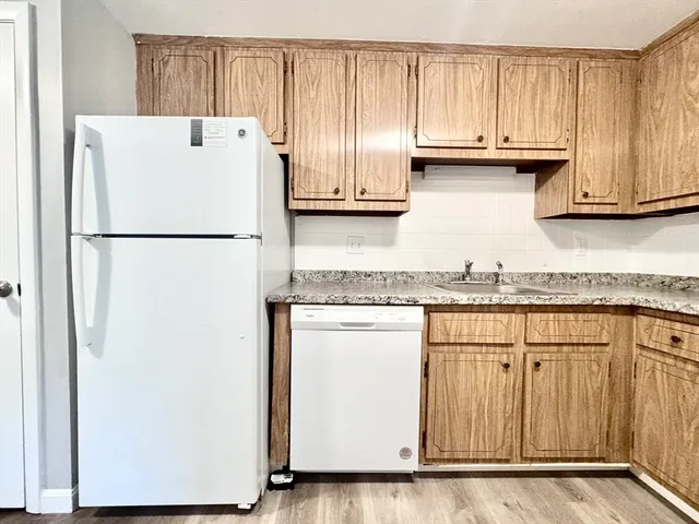 a white refrigerator freezer sitting inside of a kitchen