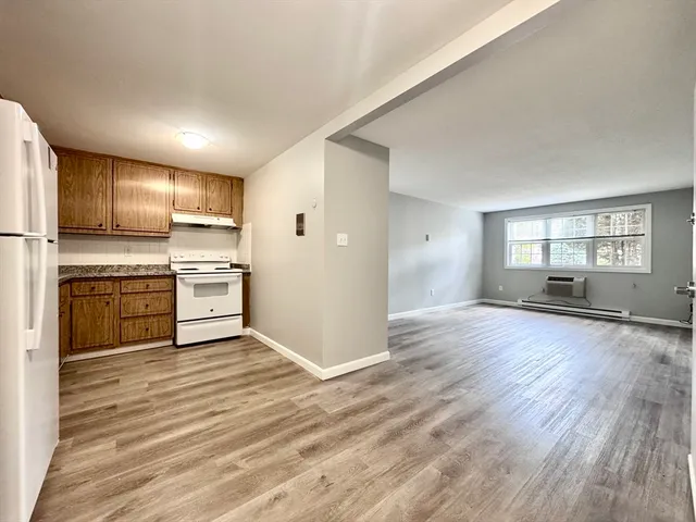 a view of kitchen with wooden floor electronic appliances and window